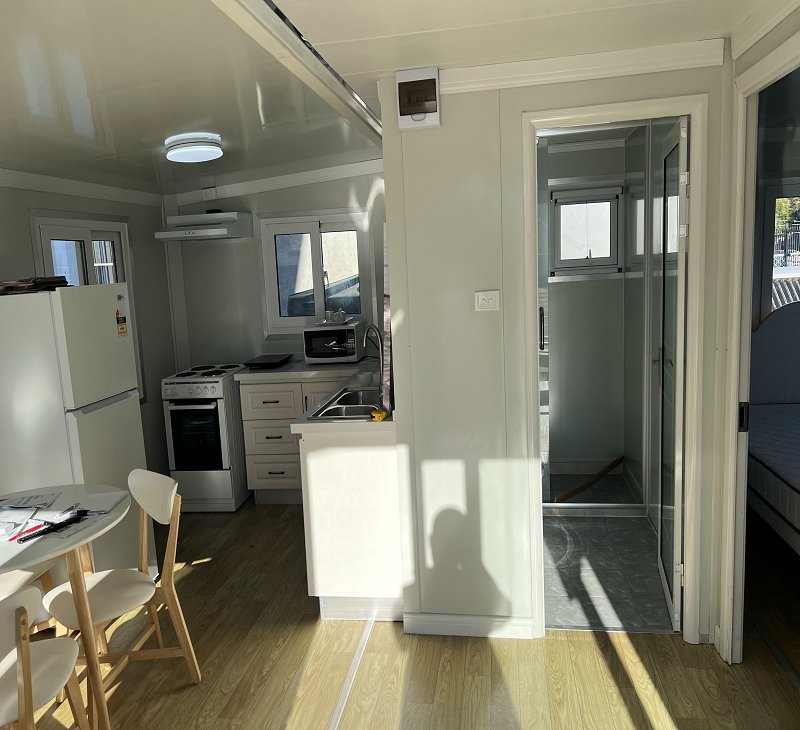 Capsul studio interior with full kitchen, living space and bathroom